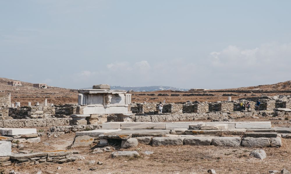 3. Sacred Precinct
Another place you can't miss when exploring the top attractions in Delos is the Sacred Precinct. It's probably the most iconic place on the island and definitely the most important. 
The entire place is dedicated to Apollo's worship and dates back thousands of years. From the main gateway, you can explore the three temples of Apollo at your own pace and see everything that is here. You will find the Keraton temple at the center, which was the most important of all Delian temples in ancient times.
The entire area is beautiful and unique in its own way, with many different buildings and columns. It's a place that definitely takes your breath away, as you appreciate how old it is and what it must have been like for the ancient people to worship here.
Overall, visiting the Sacred Precinct is definitely one of the top things to do in Delos and something you shouldn't miss if you are coming here. It's so peaceful and serene, with a magical atmosphere. It's one of the most beautiful areas in all of Greece, and it's where I felt closest to the gods. 
