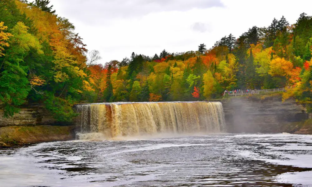 10. Tahquamenon Falls
You can't talk about Michigan waterfalls without mentioning Tahquamenon Falls. This is one of the most popular tourist attractions in the state, known for its dramatic size and picturesque setting. And with two distinct waterfalls, the Tahquamenon Falls are among the largest waterfalls east of the Mississippi River.
The Upper Falls is the more impressive of the two, with a drop of nearly 50 feet. The lower fall is also quite impressive, with a drop of 22 feet. Both falls are best viewed during spring, as they create a thunderous sound as the river flows over the falls.
Things to do near Tahquamenon Falls: There are plenty of hiking trails in the area, as well as a campground if you want to make a weekend of it. In addition, this waterfall is located in Tahquamenon Falls State Park, which offers plenty of wildlife viewing opportunities.
