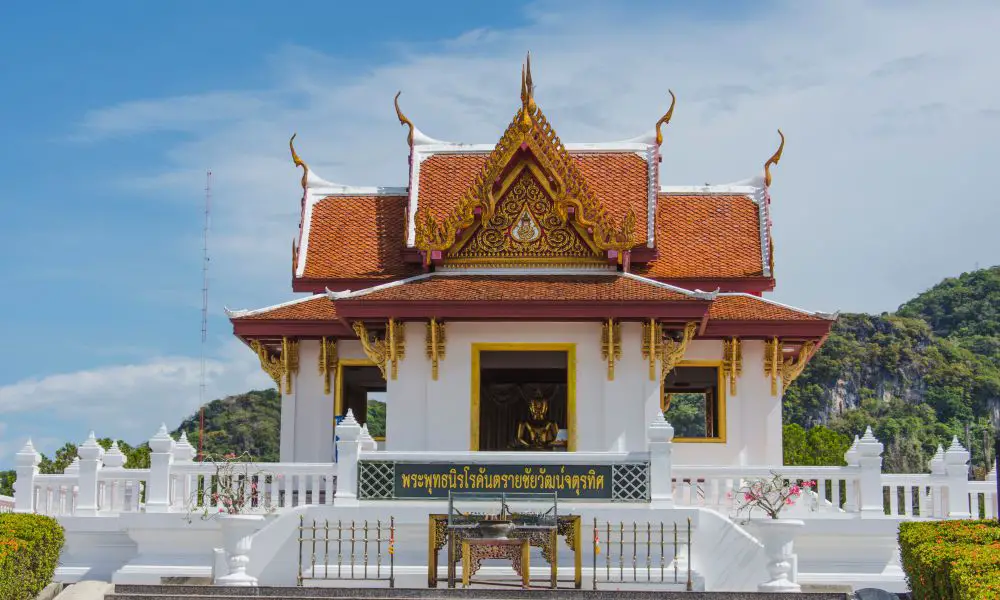 9. Visit Phra Phutthanirokhantarai Chaiwat Chaturathit
You can’t come to Phatthalung without seeing Phra Phutthanirokhantarai Chaiwat Chaturathit, one of the most important Buddhas in the province. This Buddha image was donated by His Majesty King Bhumibol Adulyadej to the province in the late 1960s.
It’s a beautiful bronze statue in meditation posture and is sacred to the locals of Phatthalung. Many people come to worship and make merit at this Buddha image, which is housed in a square pavilion that is between the provincial court and the hall.
Don't expect to see much on this site, as it's mostly just the Buddha image. However, it's still definitely worth a visit if you're interested in unique Phatthalung attractions that relate to Buddhism and culture.
