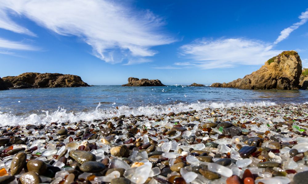 1. Glass Beach
Glass beach is undoubtedly one of the most famous beaches in Fort Bragg. In fact, you can't say you've been to this town if you haven't stopped by this beach! 
As the name suggests, the glass beach is covered in small, colorful pieces of sea glass. So, where did these pieces come from? If you take a walk down memory lane, you'll know that this beach was once used as a dumping ground for trash. 
The waves washed away most of the trash, but the glass remained. Over time, the waves would crash against the cliff and break the glass into small pieces. These pieces would then be smoothed out by the sand, giving us the beautiful sea glass that we see today.
You can't take any of the glasses home with you as it is against the law, but you can enjoy the beauty of these glasses and take some amazing photos. Just take a walk along the shoreline, and you'll be amazed by the colors of the glass.
